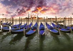 Gondolas at St. Mark's Square with the island Isola di San Giorgio Maggiore and a cloudy sky in the evening light, Venice, Veneto, Italy, Europe