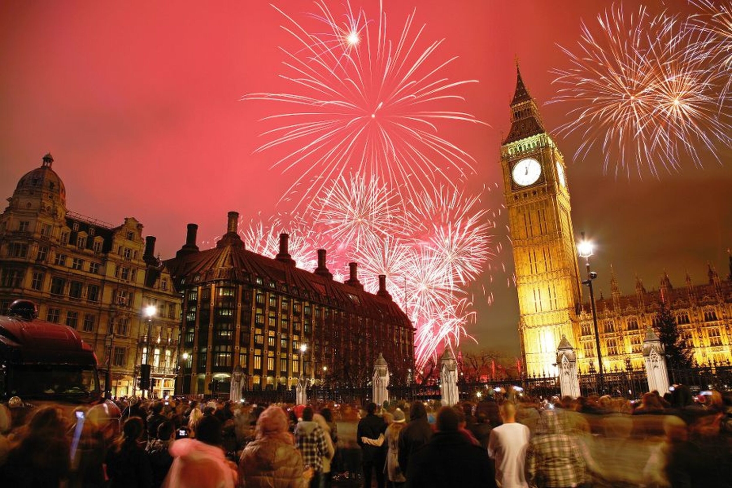 Menschenmenge schaut Feuerwerk über Big Ben in London an.