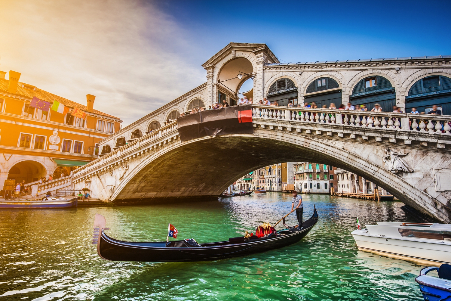 Gondel auf dem Wasser vor der Rialto-Brücke in Venedig bei Sonnenschein